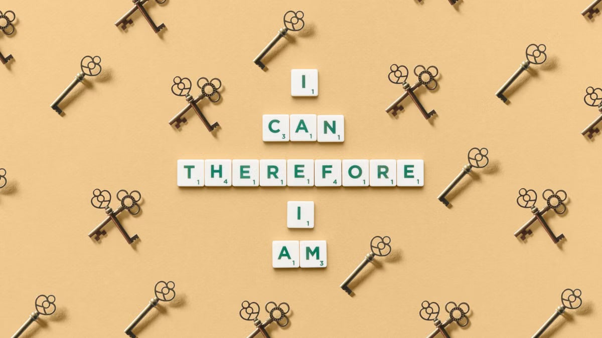 Inspirational phrase made from tiles surrounded by decorative keys on a beige background.